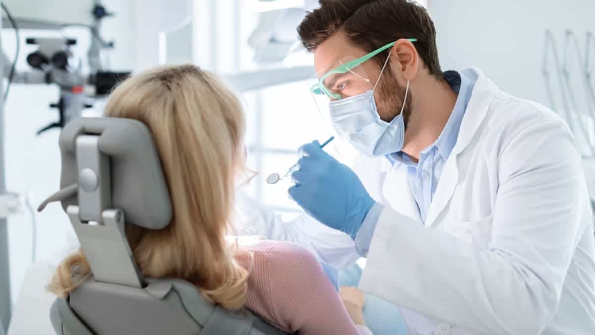Patient receiving professional teeth whitening with a laser device Hastings